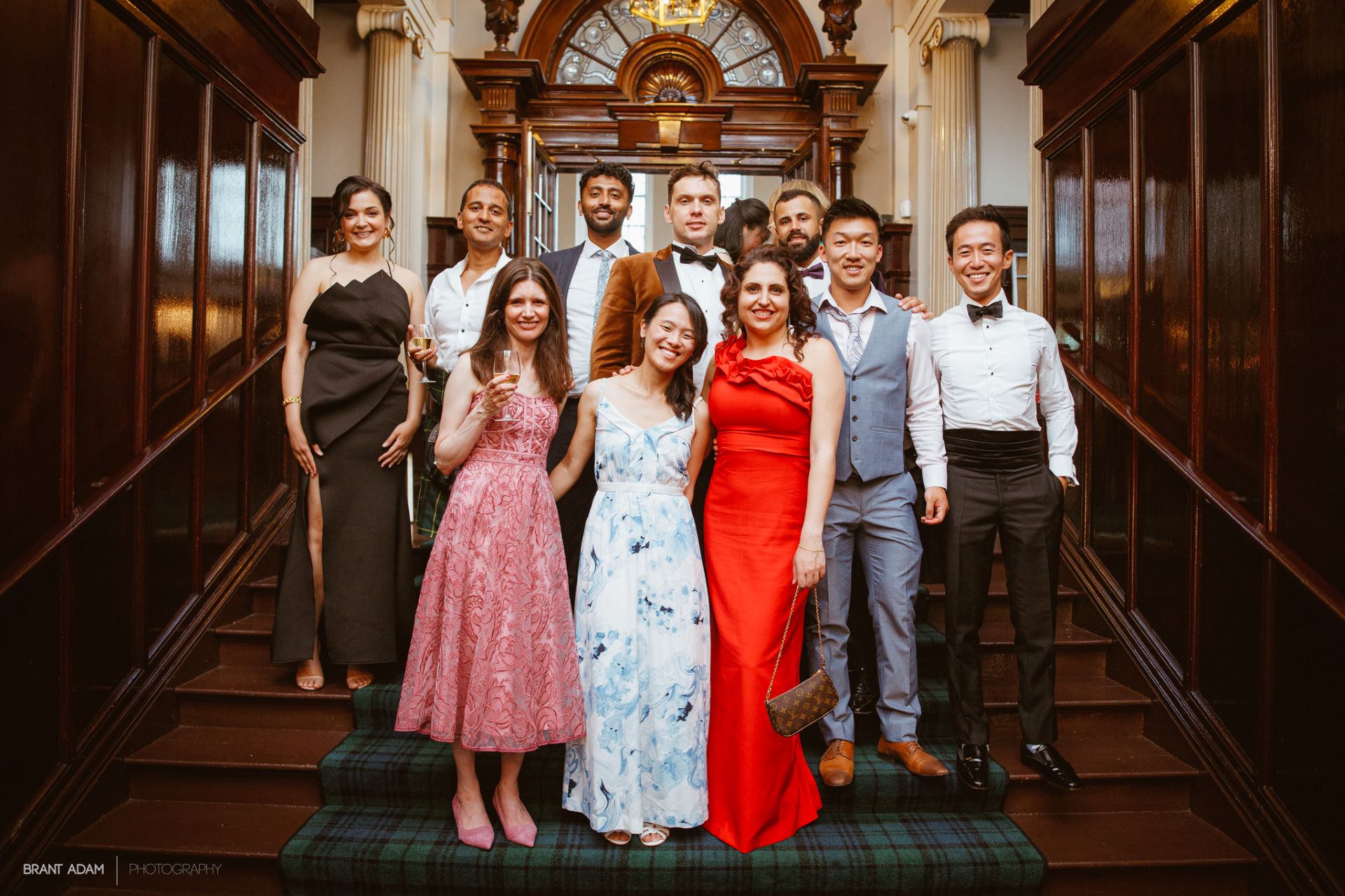 A graduation group photo on College hall stairs